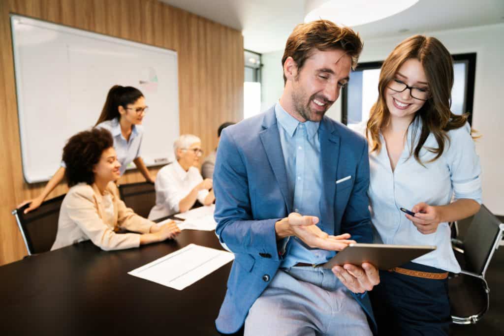 Happy business man with colleagues at a conference in office